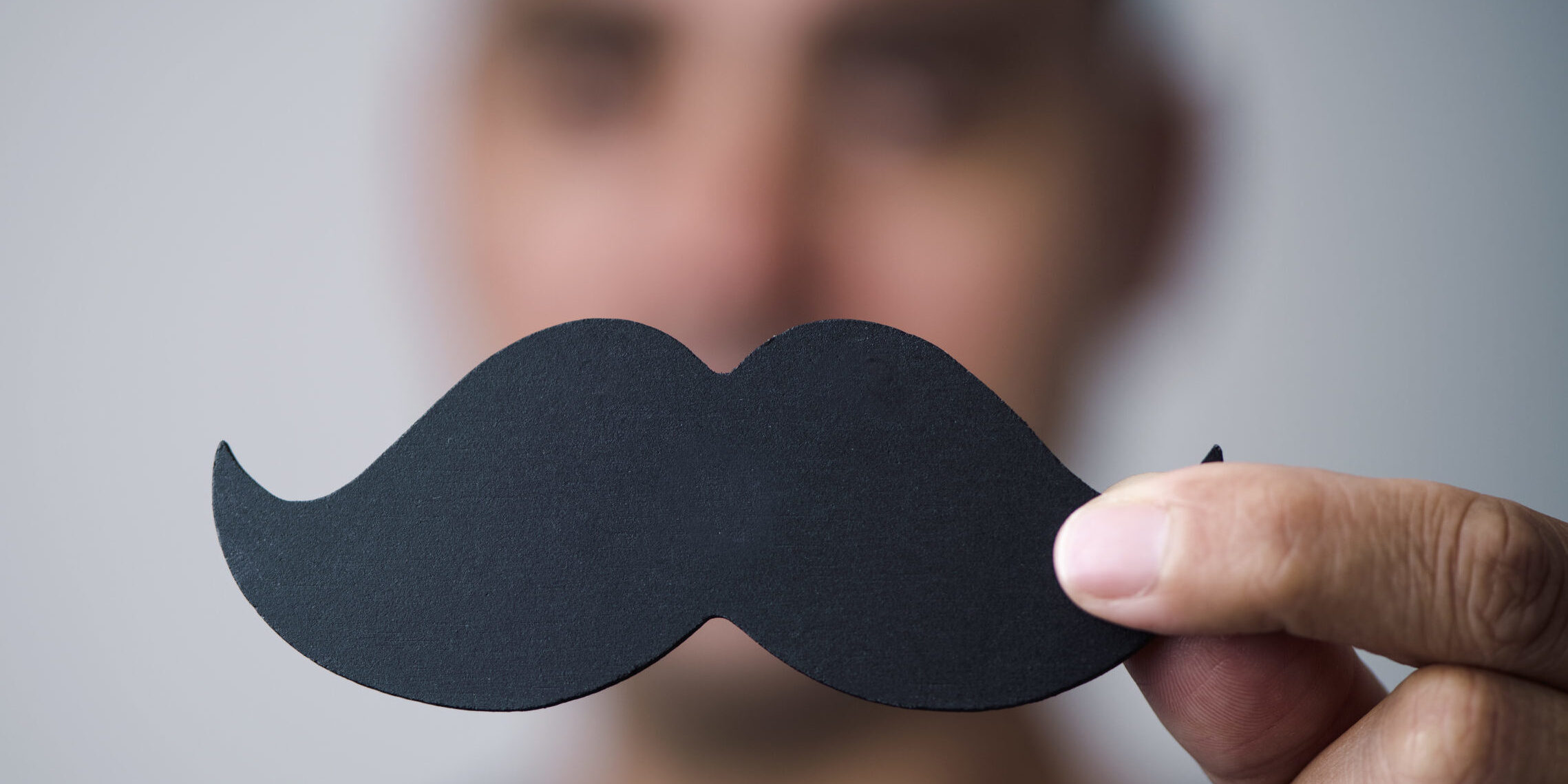 young man with a fake moustache