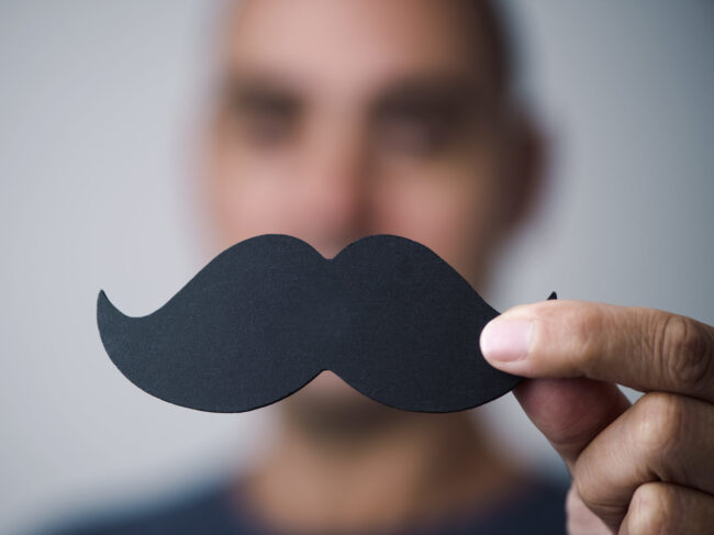 young man with a fake moustache